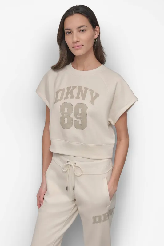 ARCHED DKNY 89 DISTRESSED RHINESTONE LOGO CROPPED sold by DKNY