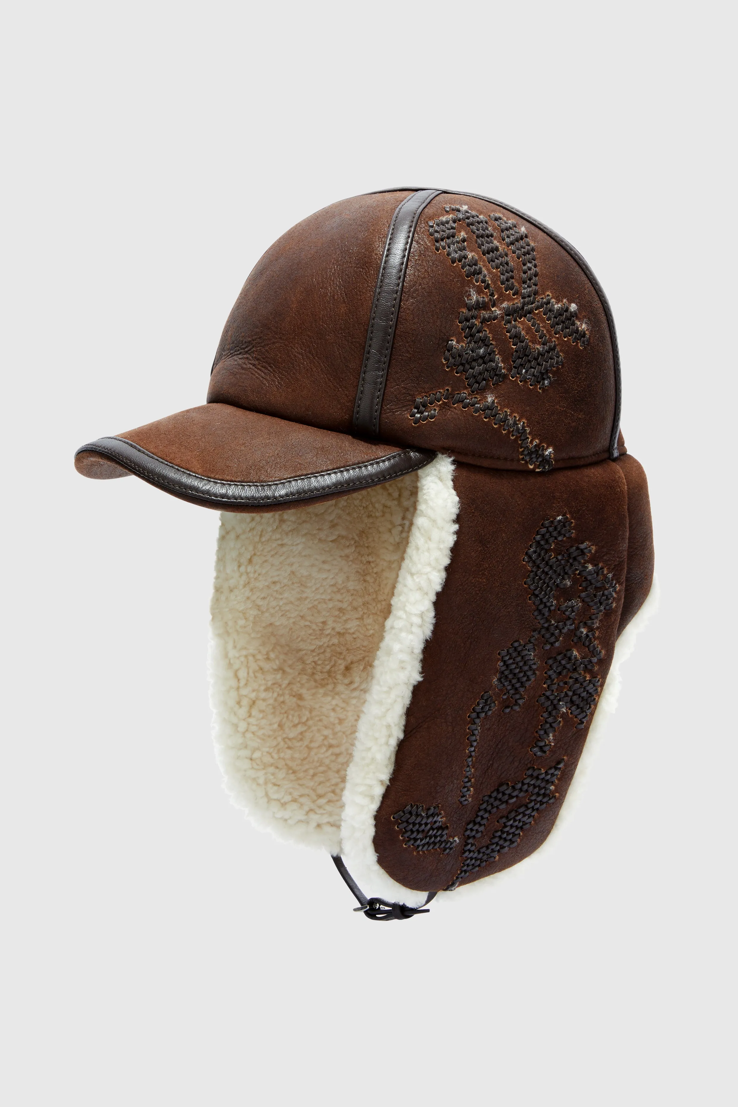 Embroidered baseball-style hat with shearling ear flaps sold by Ermanno Scervino