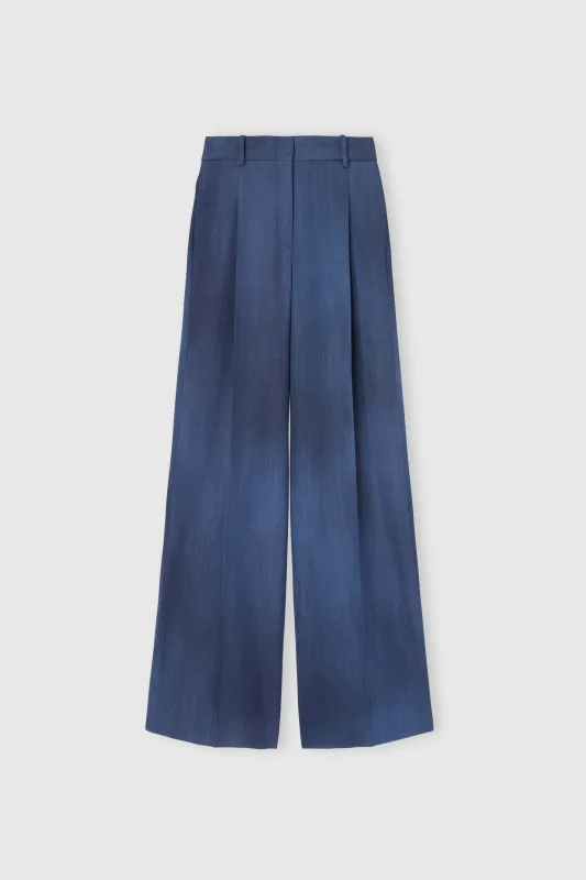 Palazzo trousers in denim-print marocain sold by Ermanno Scervino