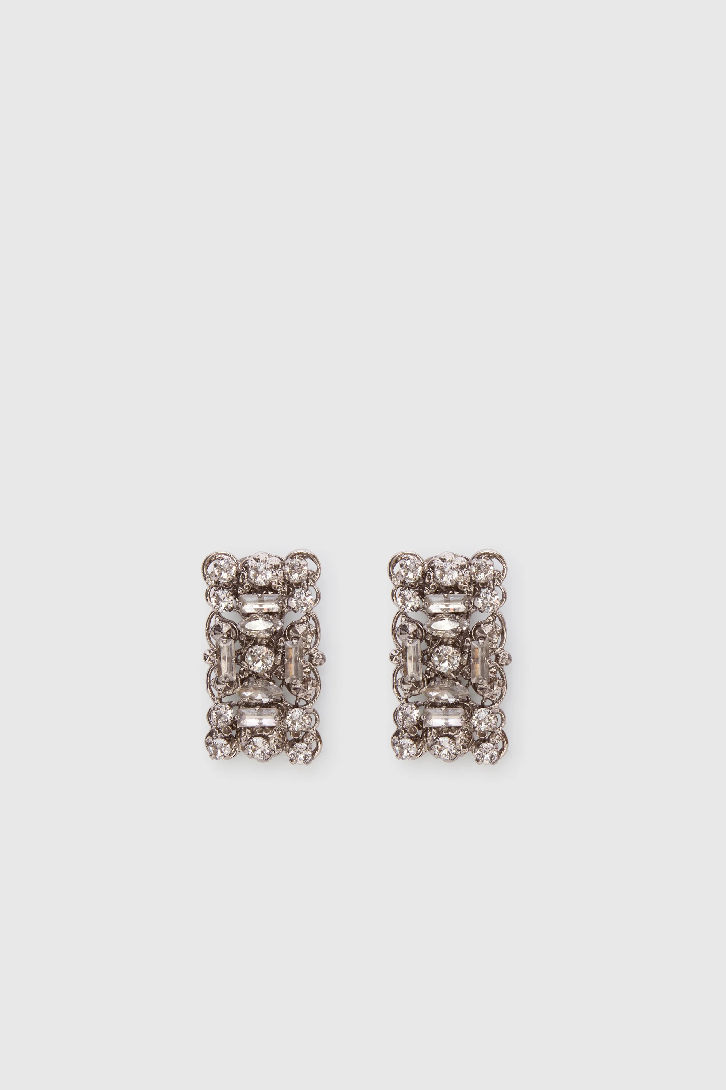 Filigree brass jewel earrings with crystals sold by Ermanno Scervino