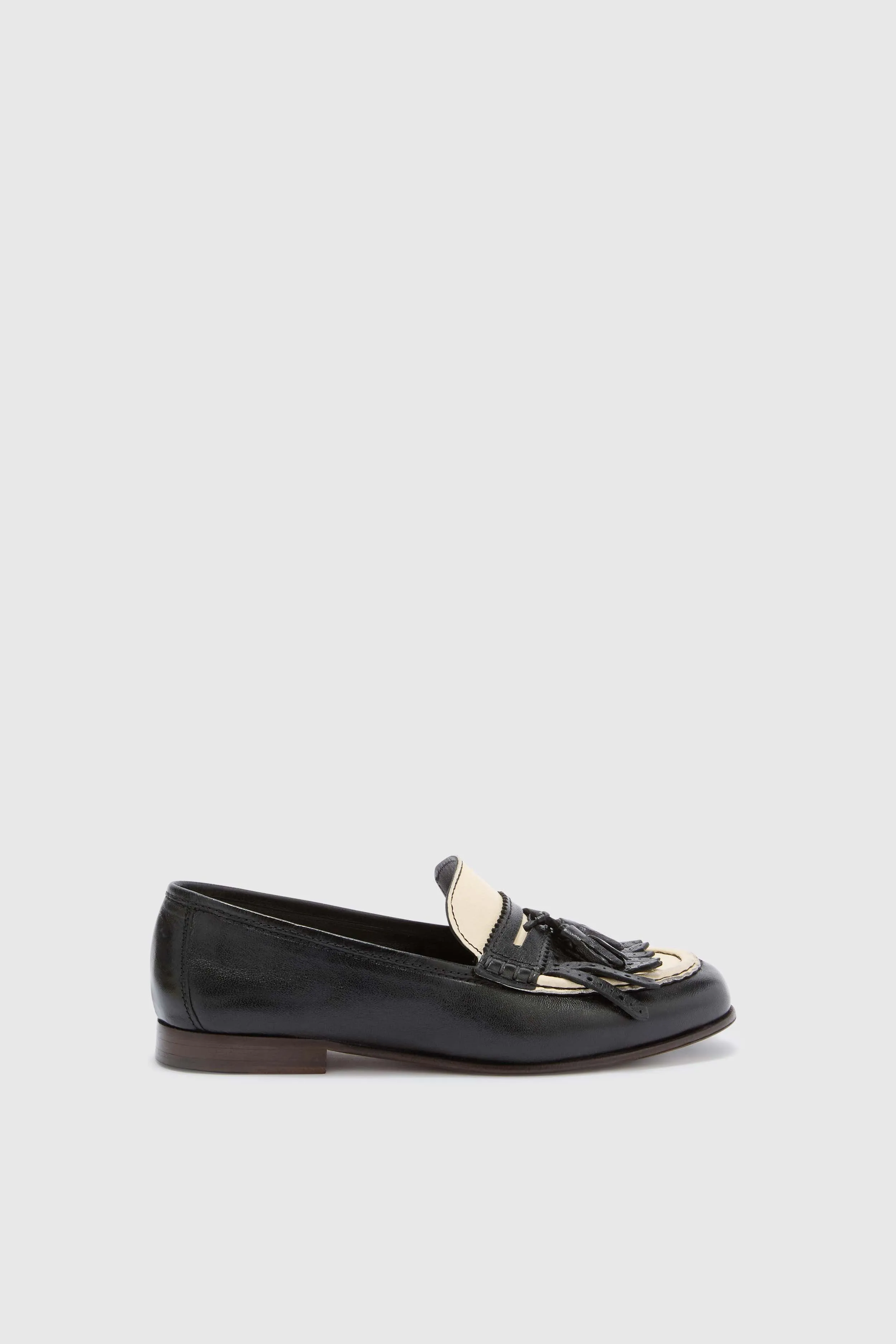 Black College loafers in vintage-effect shearling leather with tassels sold by Ermanno Scervino
