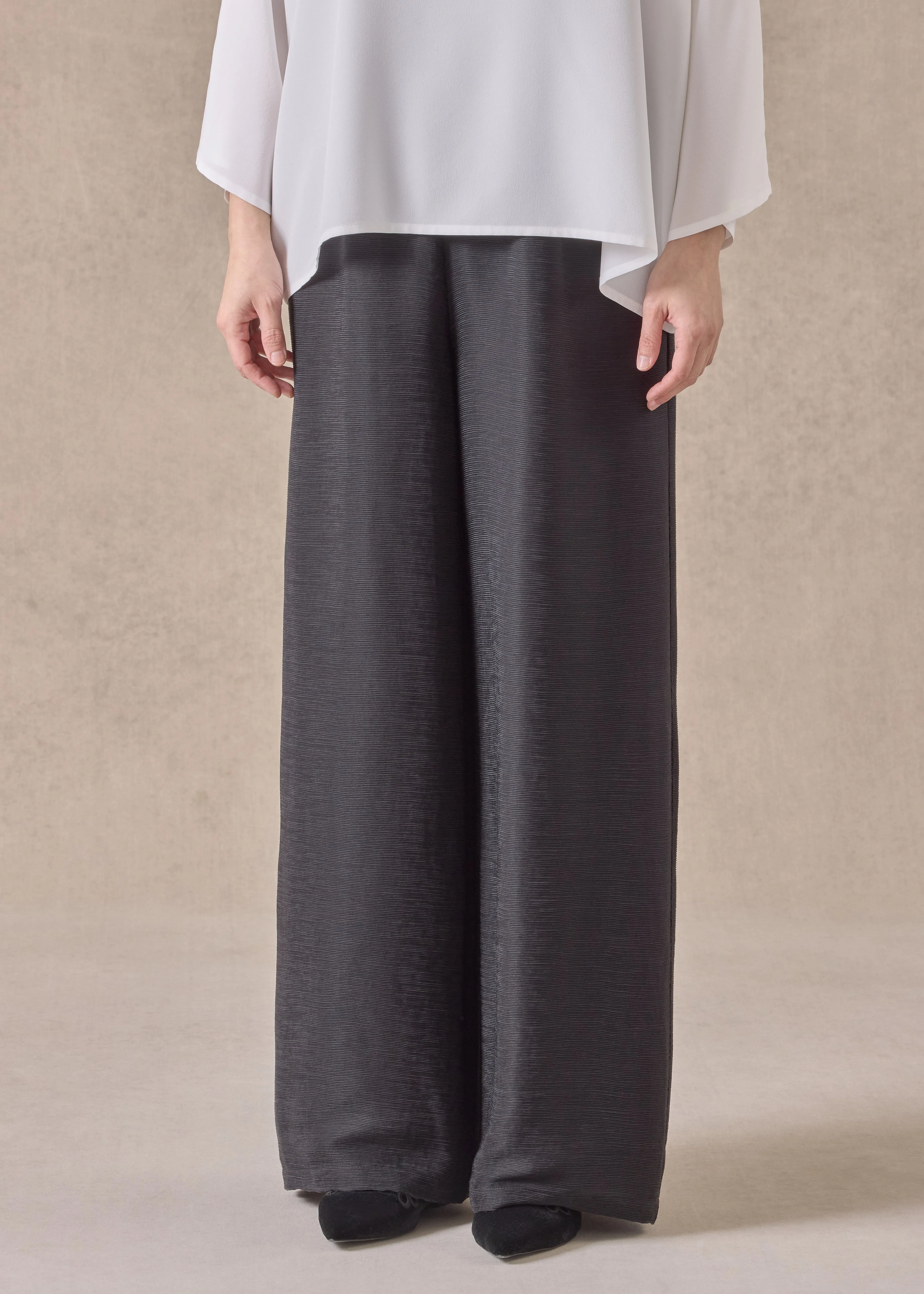 lightweight silk plisse flared trouser (black) sold by eskandar