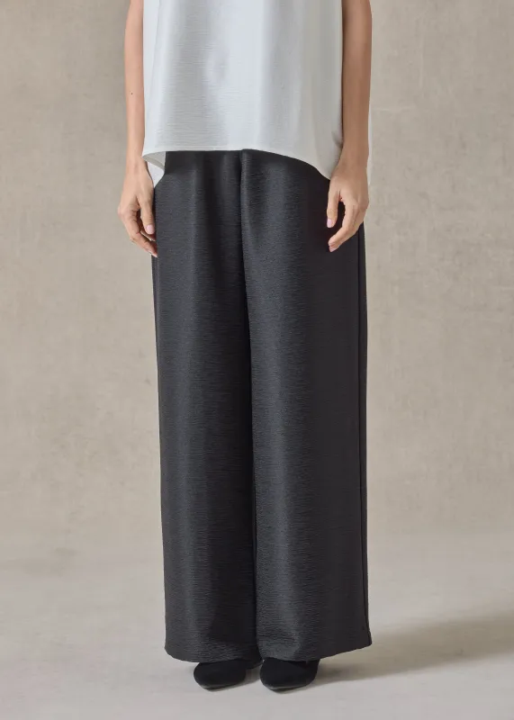 midweight silk plisse flared trouser (black) sold by eskandar