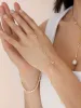 Dripping Crystal Hand Chain sold by ettika