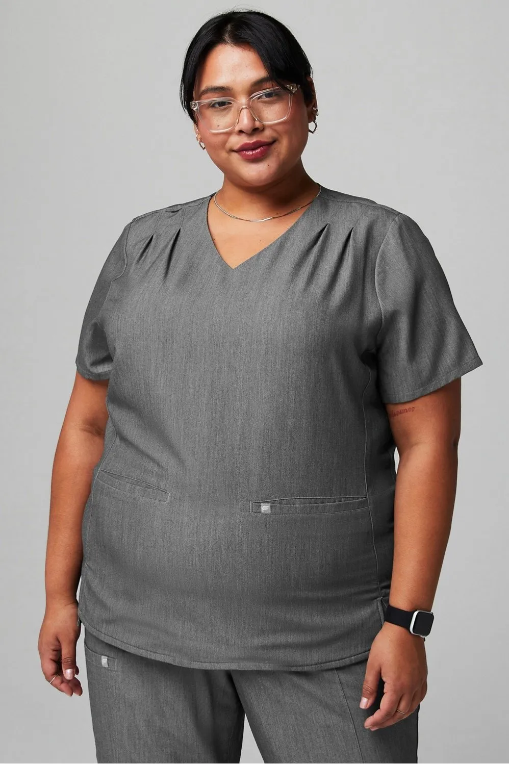 Stat Pleat 3-Pocket Scrub Top sold by Fabletics