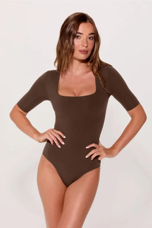 Nearly Naked Shapewear 3/4 Sleeve Bodysuit sold by Fabletics