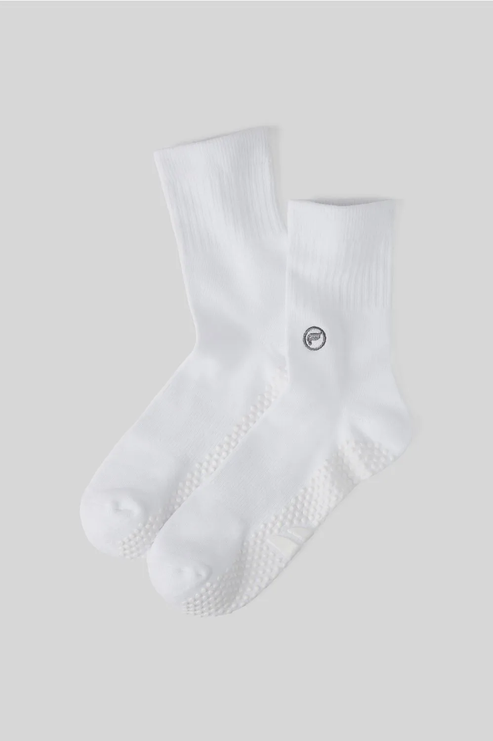 The Powerhouse Quarter Crew Grip Sock sold by Fabletics