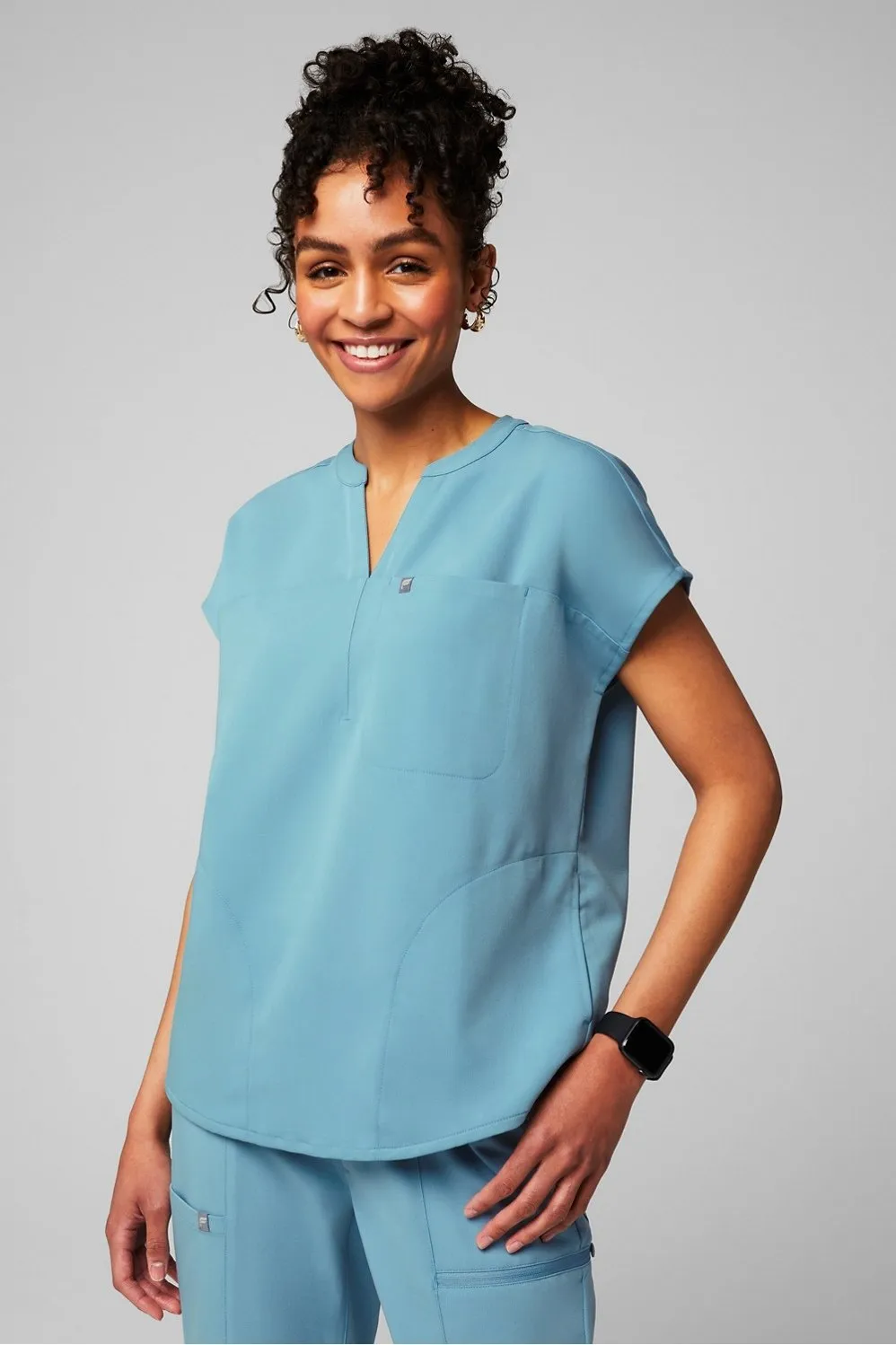 Evolve 3-Pocket Scrub Top sold by Fabletics