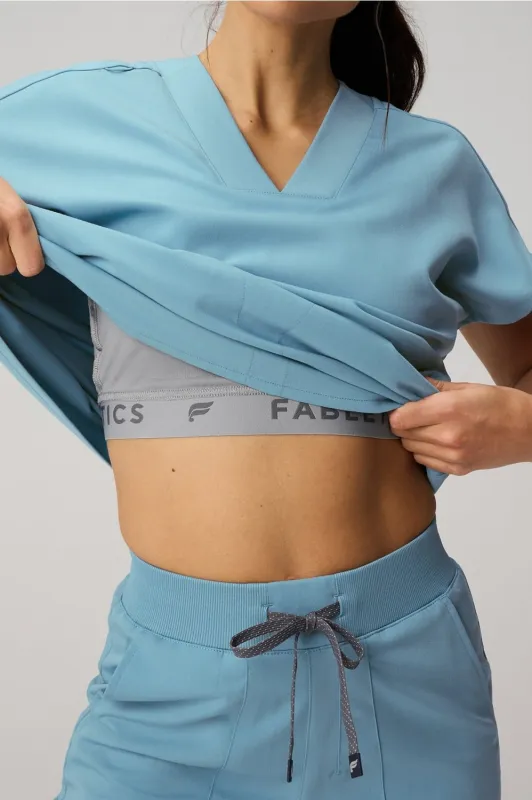 360° Built-In Bra Scrub Top sold by Fabletics