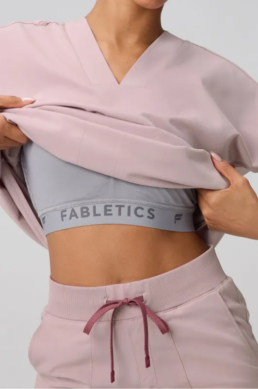360° Built-In Bra Scrub Top sold by Fabletics