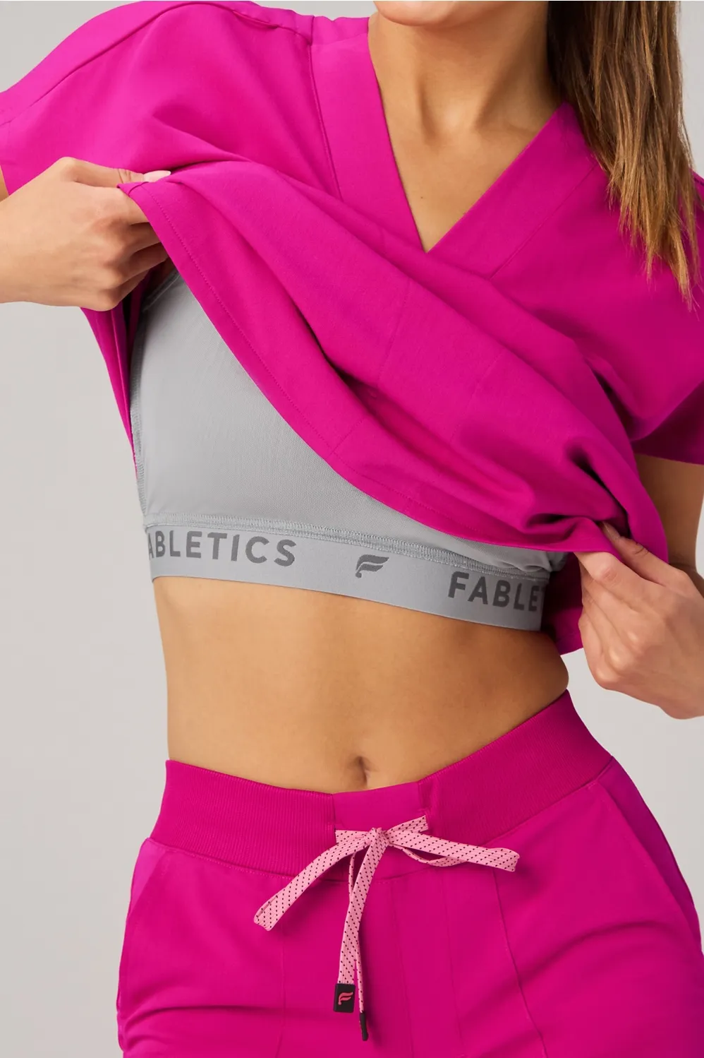 360° Built-In Bra Scrub Top sold by Fabletics