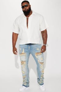 Torn Apart Stacked Skinny Flare Jeans - Light Blue Wash sold by Fashion Nova