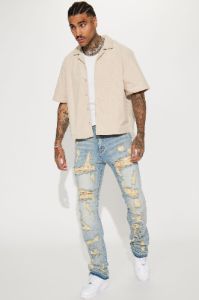 Torn Apart Stacked Skinny Flare Jeans - Light Blue Wash sold by Fashion Nova