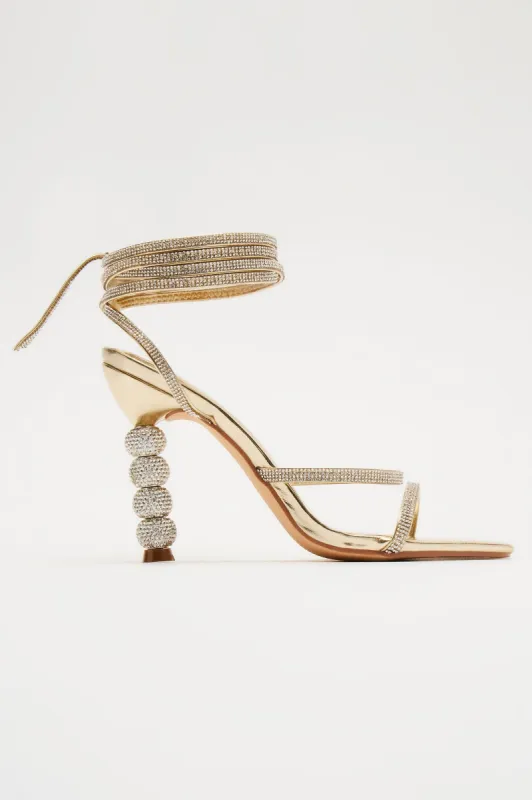 All The Glamour Embellished Wrap Up Heeled Sandals - Gold sold by Fashion Nova