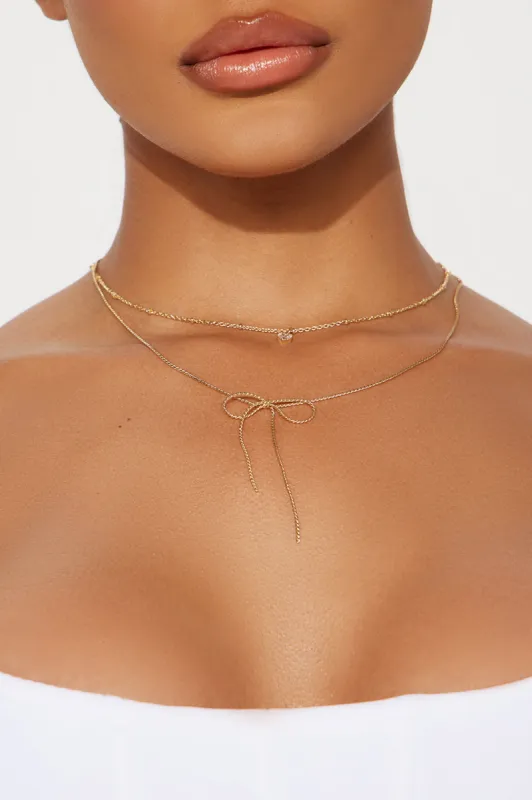 Finishing Touch Bow Necklace - Gold sold by Fashion Nova