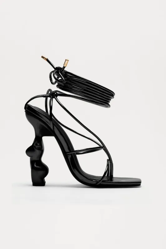 News Worthy Novelty Wrap Up Heels - Black sold by Fashion Nova