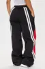 Mark Your Winnings Windbreaker Track Pant - Black/Red sold by Fashion Nova