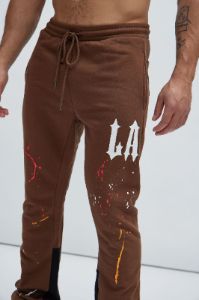 LA Scrap Art Sweatpant - Brown sold by Fashion Nova