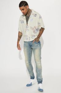 Street Rising Ripped Stacked Skinny Jeans - Medium Wash sold by Fashion Nova