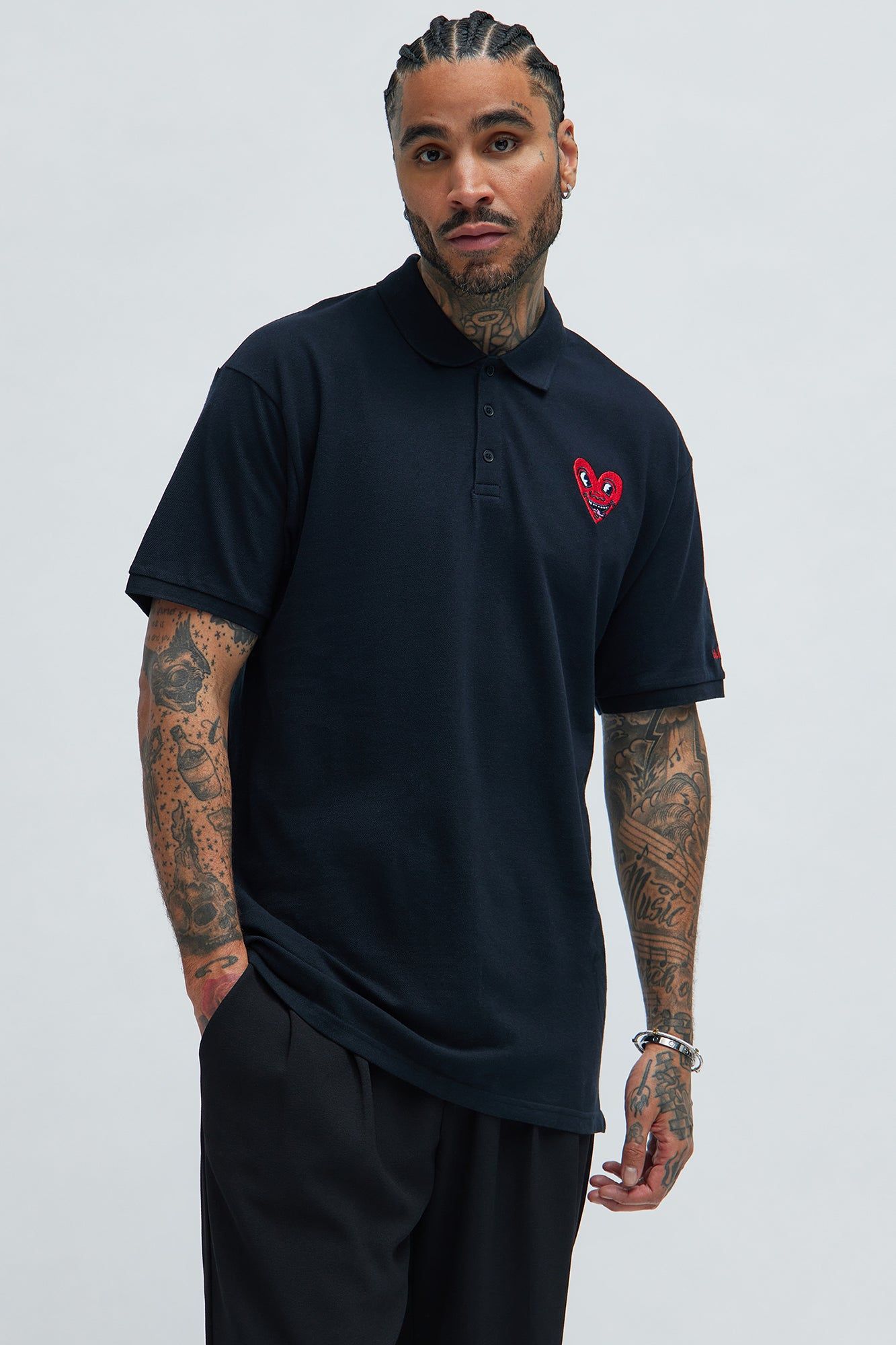 Keith Haring Heart Logo Short Sleeve Polo - Black sold by Fashion Nova