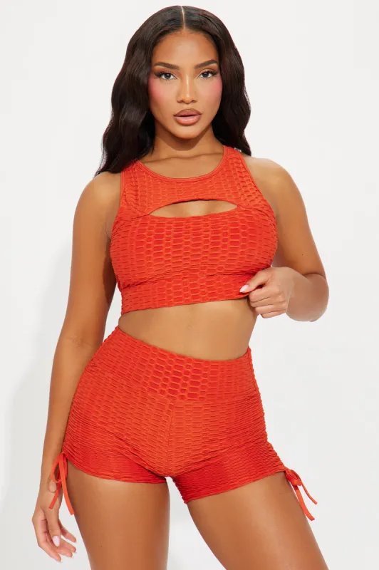 The Best Assets Textured Cut Out Sports Bra - Orange sold by Fashion Nova