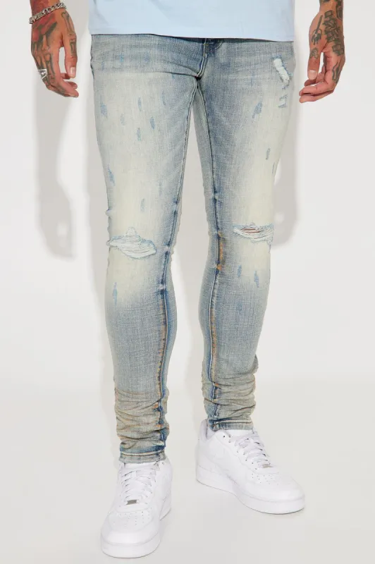 Drop It Ripped Knee Stacked Skinny Jeans - Medium Wash sold by Fashion Nova