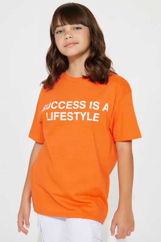 Mini Success Is A Lifestyle Graphic T-Shirt - Orange sold by Fashion Nova