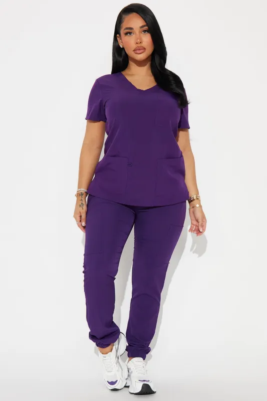 Working Overtime Jogger 4FLEX Uniform Scrub Set - Eggplant sold by Fashion Nova