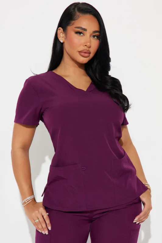 Working Overtime 4FLEX Uniform Scrub Top - Wine sold by Fashion Nova