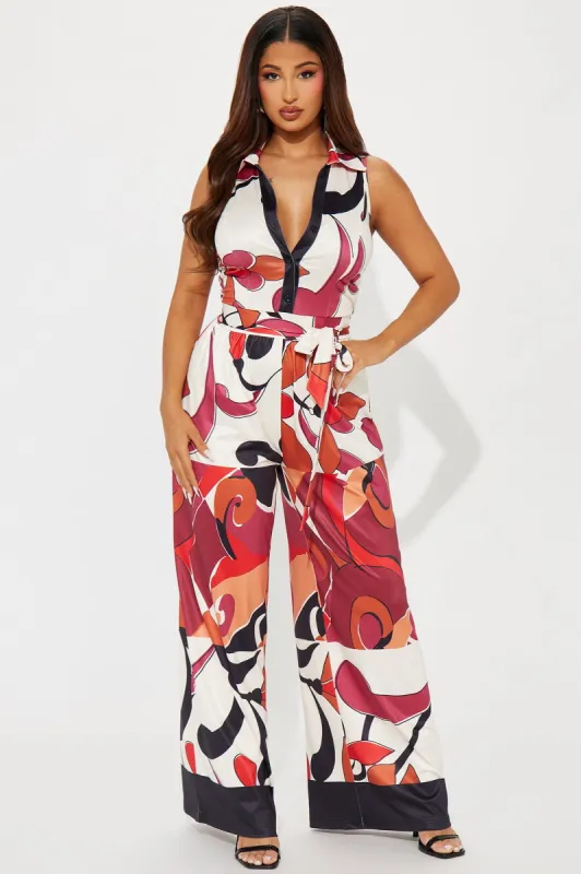 This Energy Jumpsuit  - Rust/combo sold by Fashion Nova