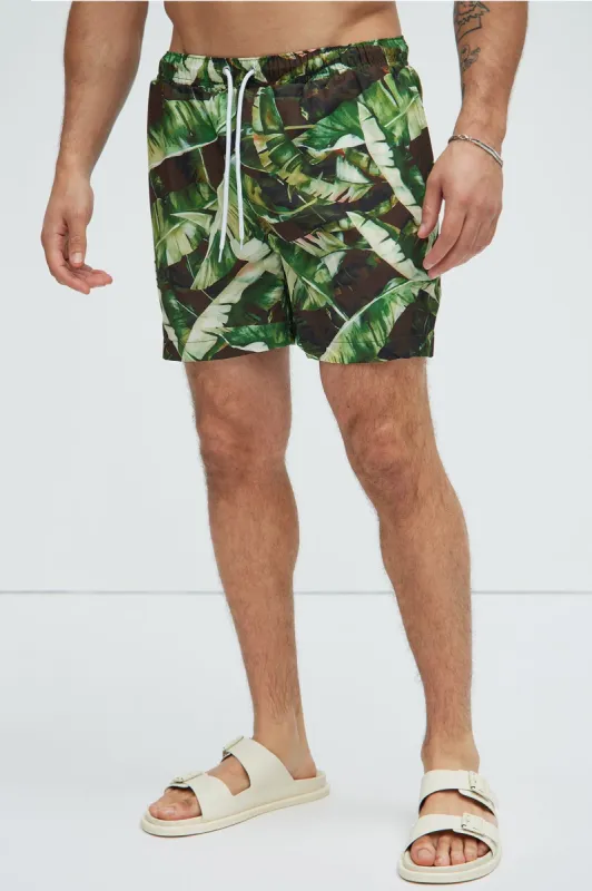 See Past Palms Swim Trunks - Green/combo sold by Fashion Nova