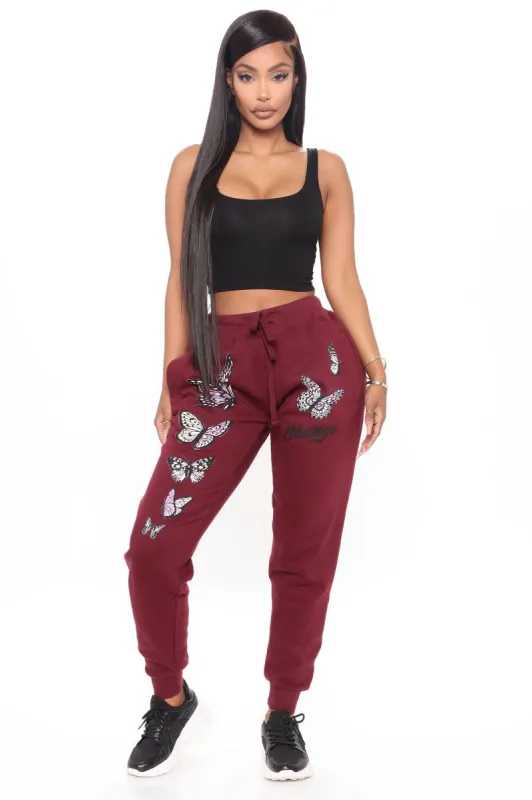 Be The Change Butterfly Sweatpants - Burgundy sold by Fashion Nova