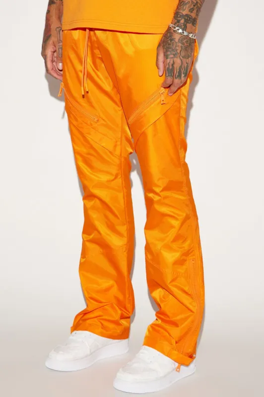 Play The Track Stacked Slim Flare Nylon Pants - Orange sold by Fashion Nova