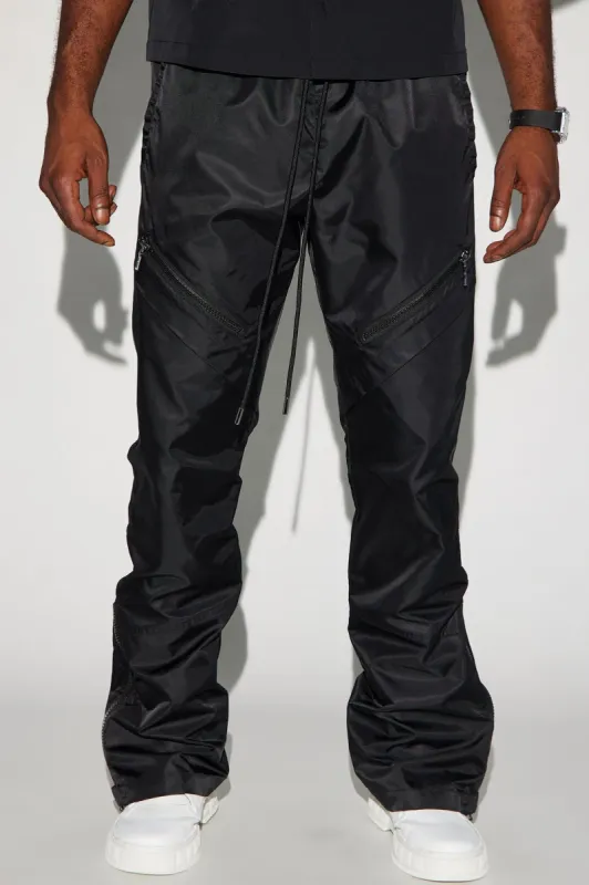 Play The Track Stacked Slim Flare Nylon Pants - Black sold by Fashion Nova