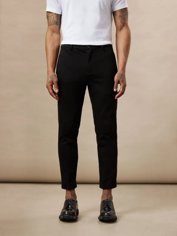 The Colin Tapered Fit Flex Pant in Black sold by Frank & Oak