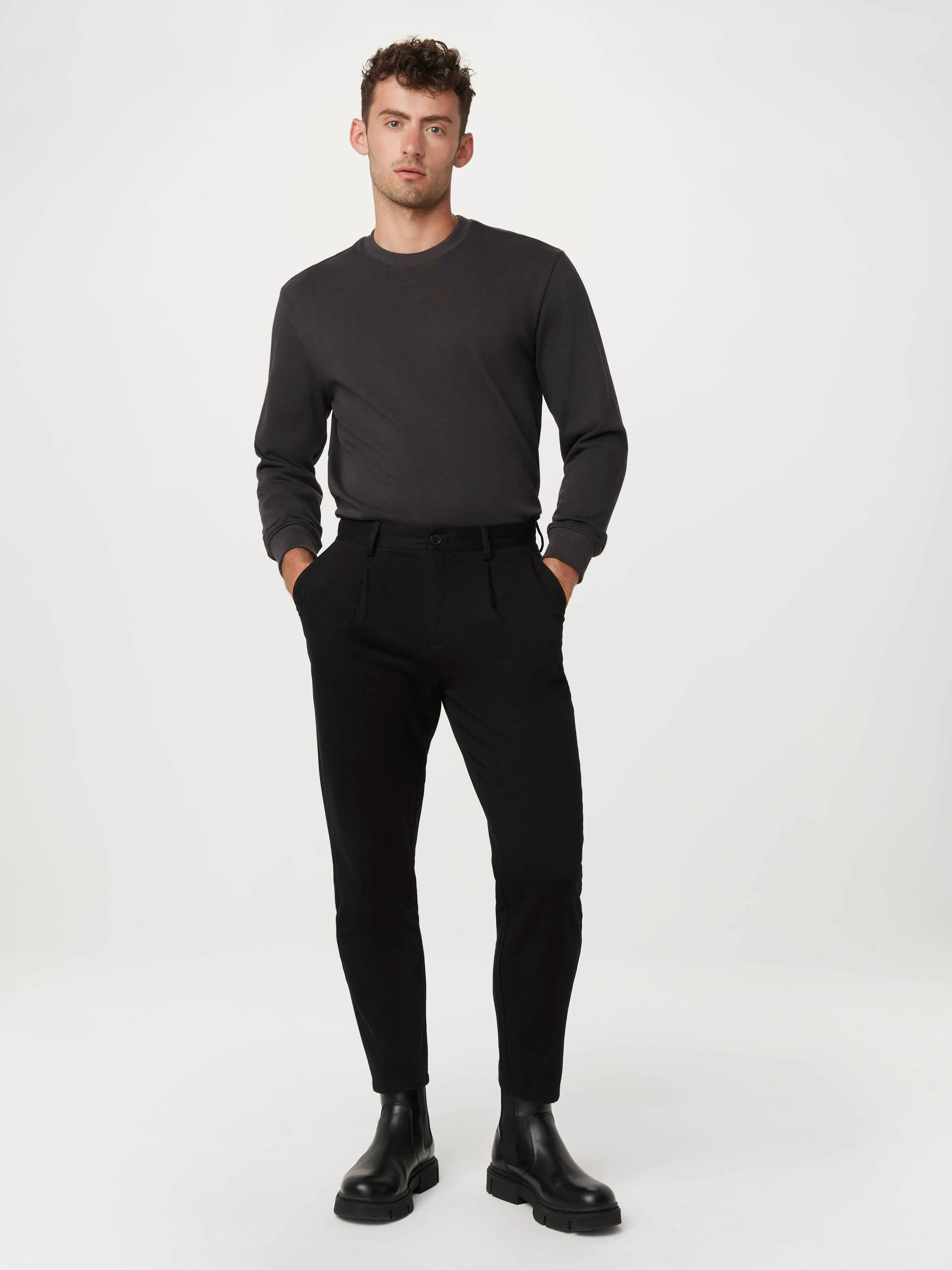 The Jamie Pleated Chino Pant in Black sold by Frank & Oak
