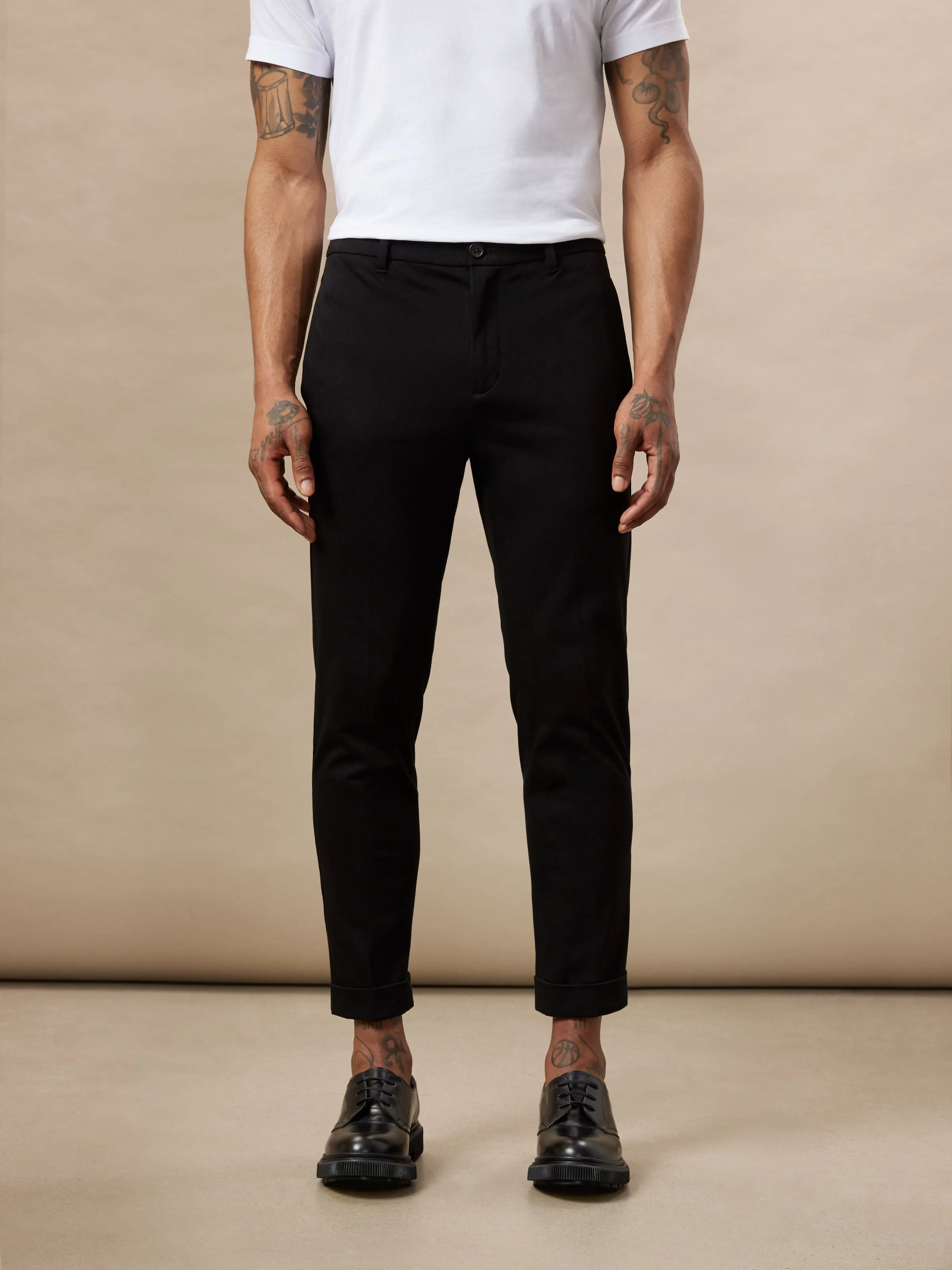 The Colin Tapered Flex Pant in Black sold by Frank & Oak