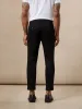 The Colin Tapered Flex Pant in Black sold by Frank & Oak