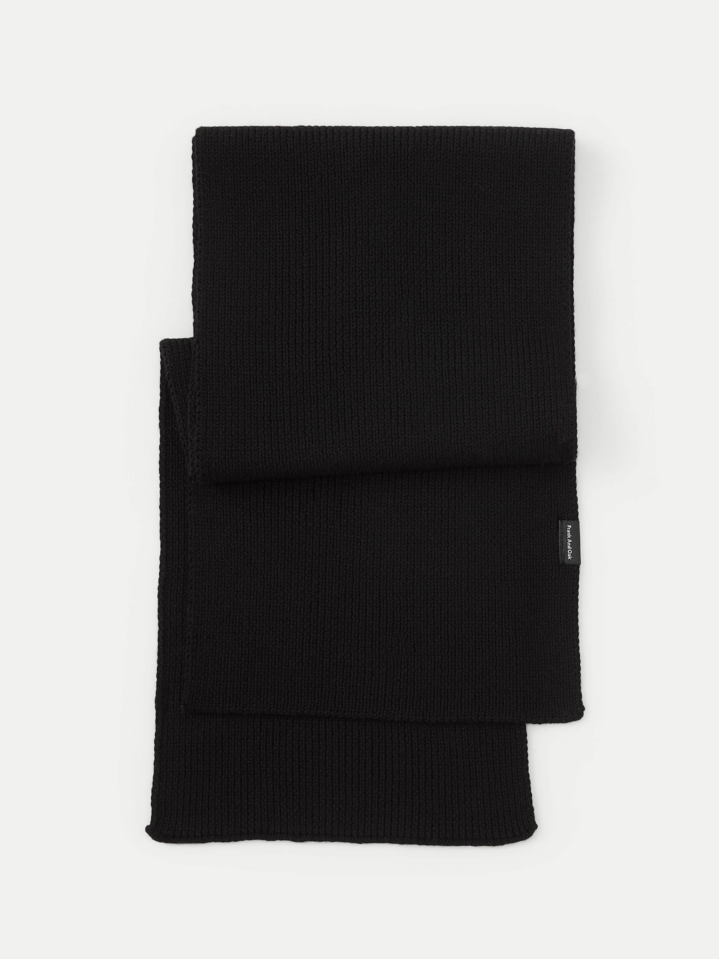 The Merino Wool Scarf in Black sold by Frank & Oak