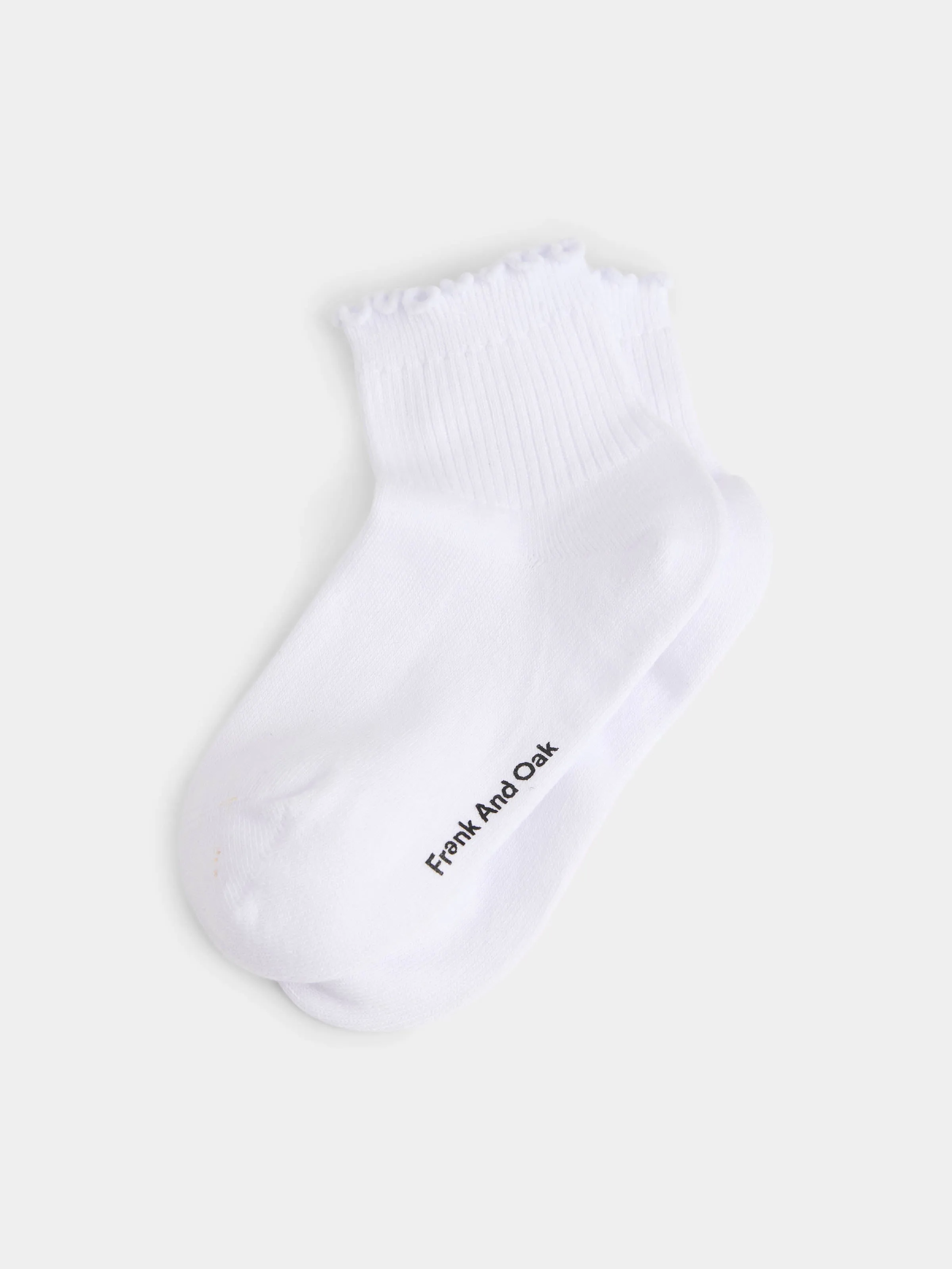 The Ruffle Trim Socks in White sold by Frank & Oak