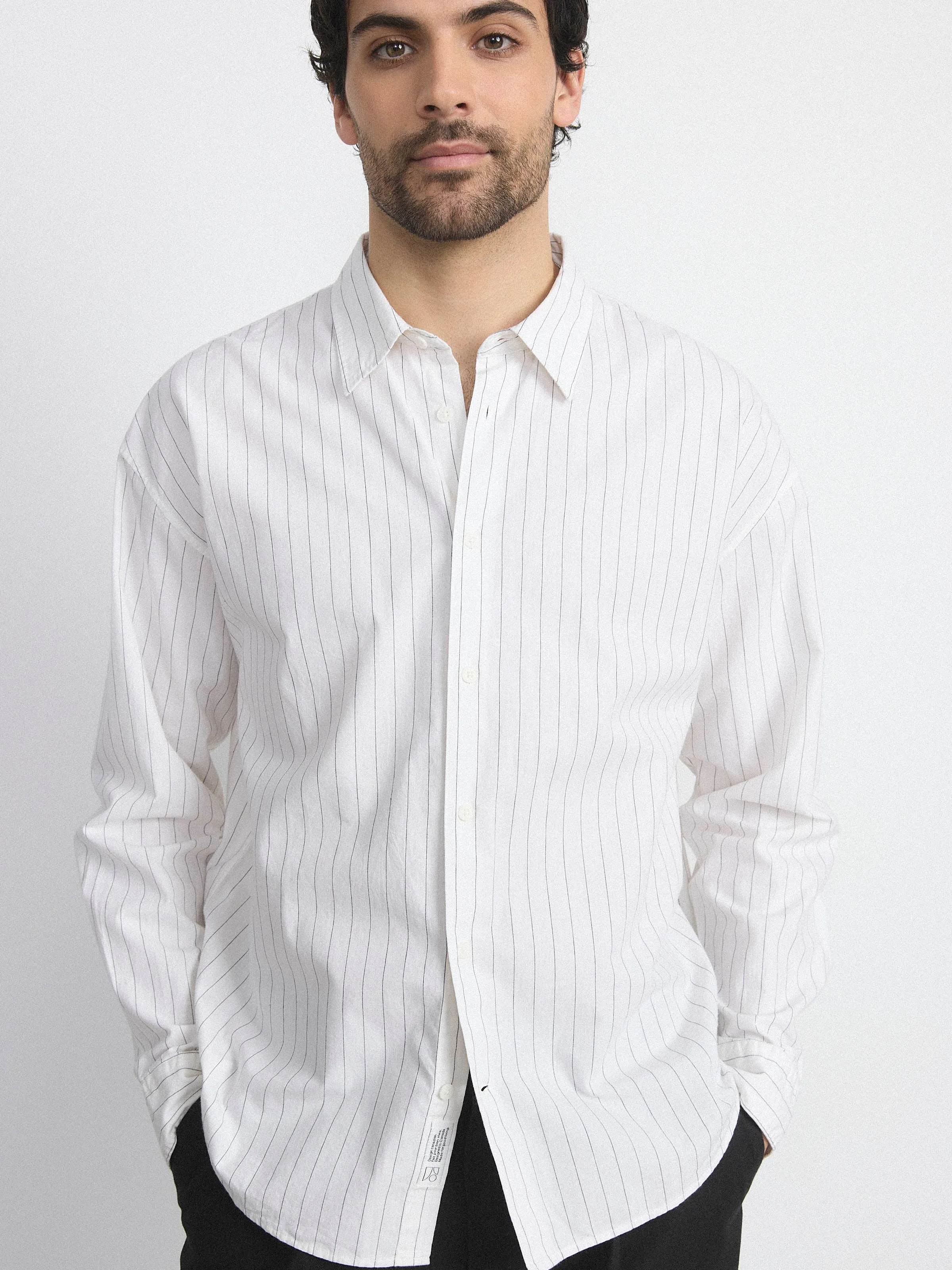 The Loose Pinstripe Shirt in White sold by Frank & Oak