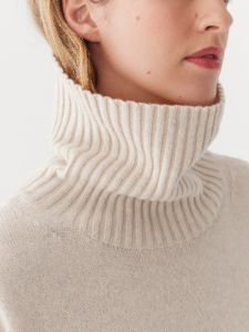 The Turtleneck Sweater Dress in Cream sold by Frank & Oak