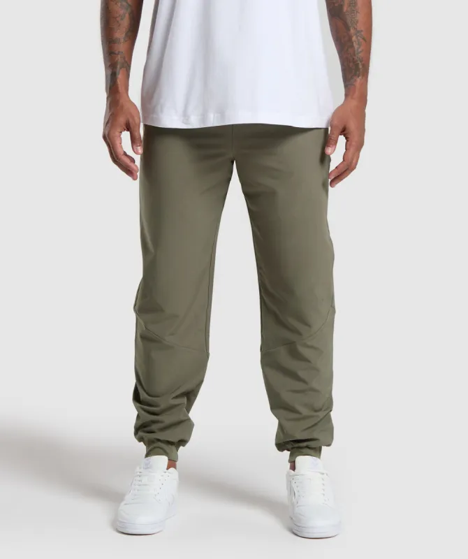 Gymshark Ease Woven Joggers - Base Green sold by Gymshark