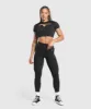Gymshark Adapt Monogram Seamless Ruched Crop Top - Black/Pitch Grey sold by Gymshark