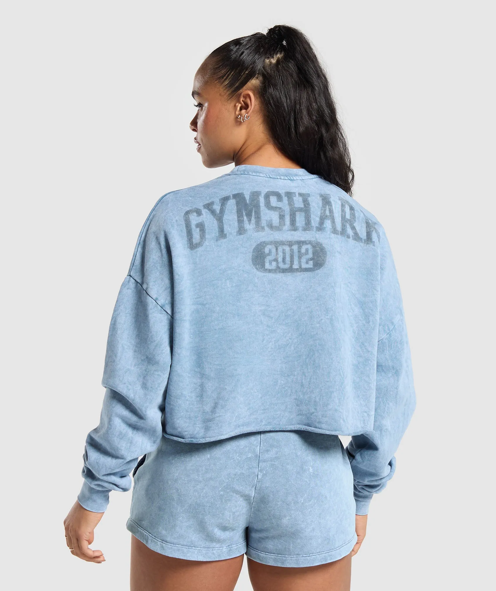 Gymshark Collegiate Shadow Washed Midi Sweatshirt - Faded Blue sold by Gymshark