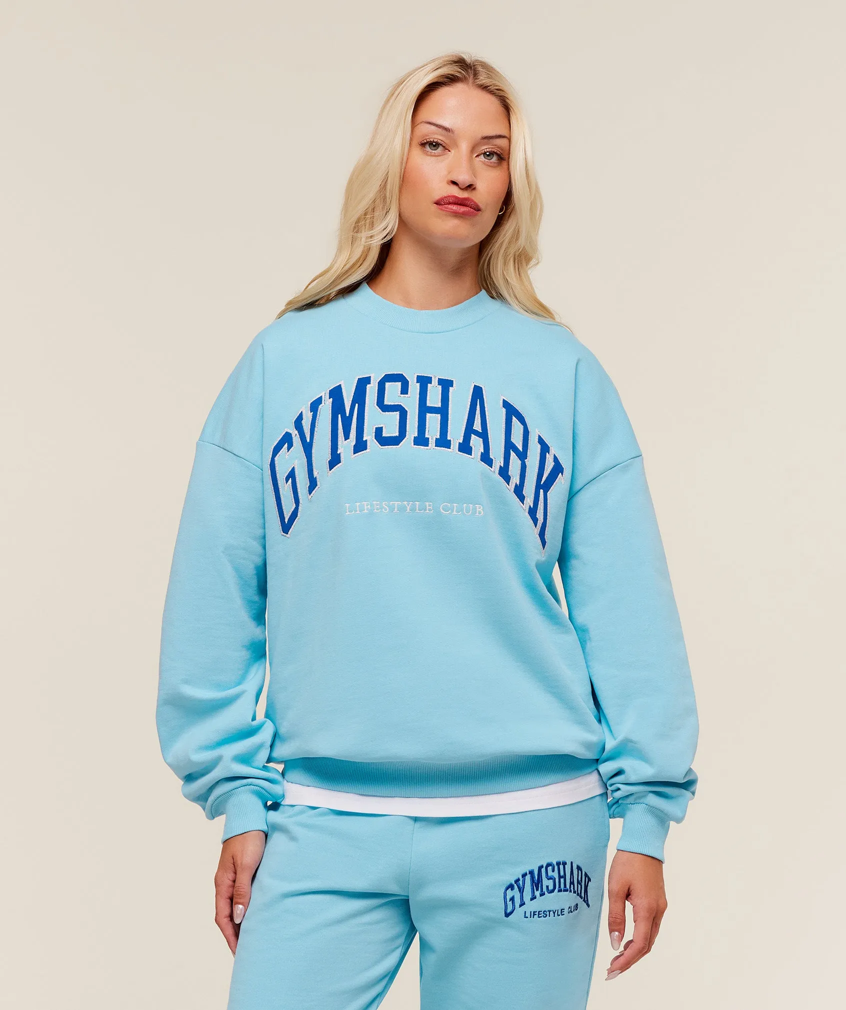 Gymshark Collegiate Graphic Crew Neck Pullover - Athletic Light Blue sold by Gymshark