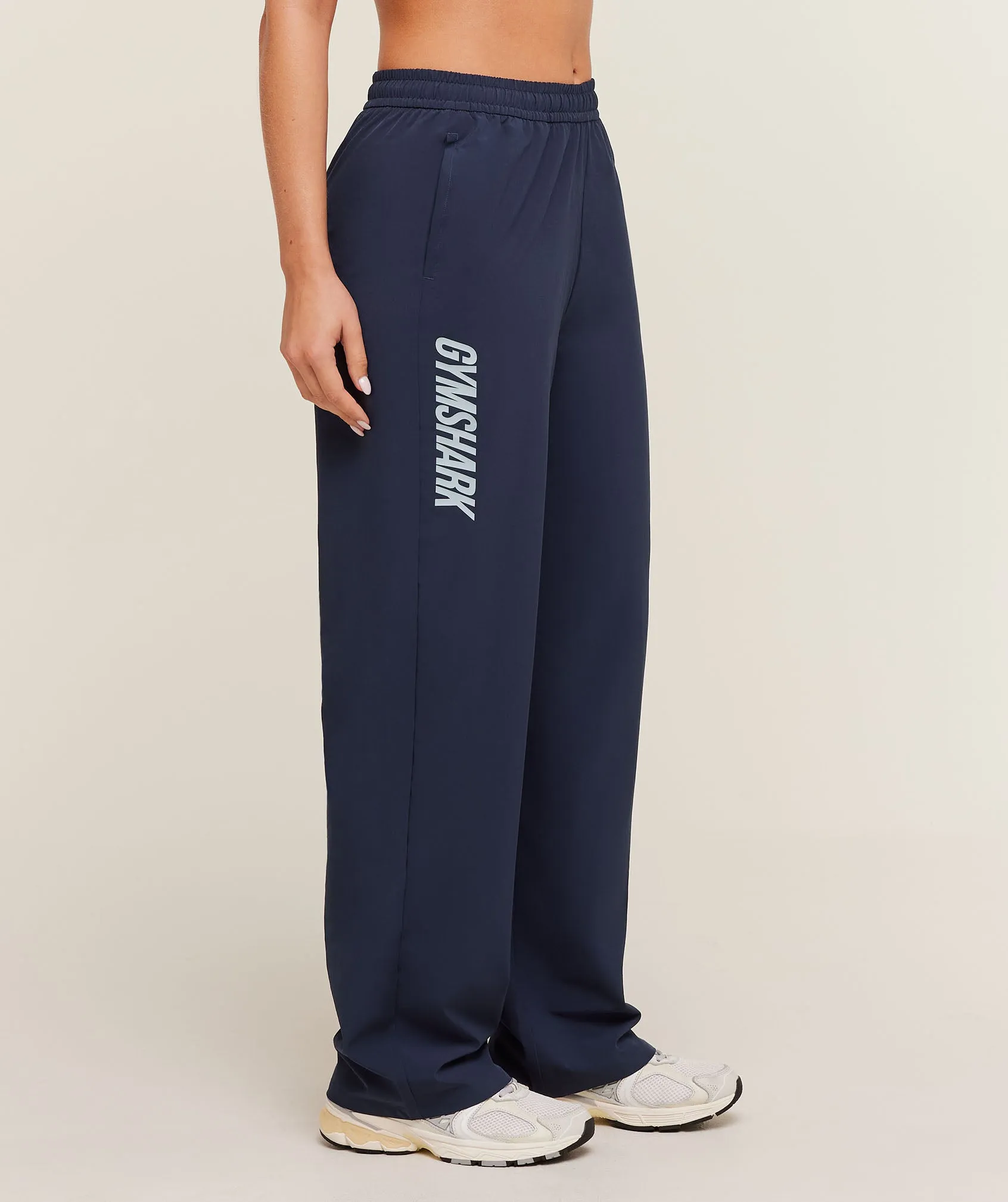 Gymshark Woven Track Straight Leg Pants - Heavy Blue sold by Gymshark