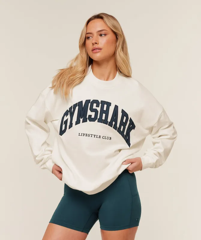 Gymshark Collegiate Graphic Crew Neck Pullover - GS Soft White sold by Gymshark