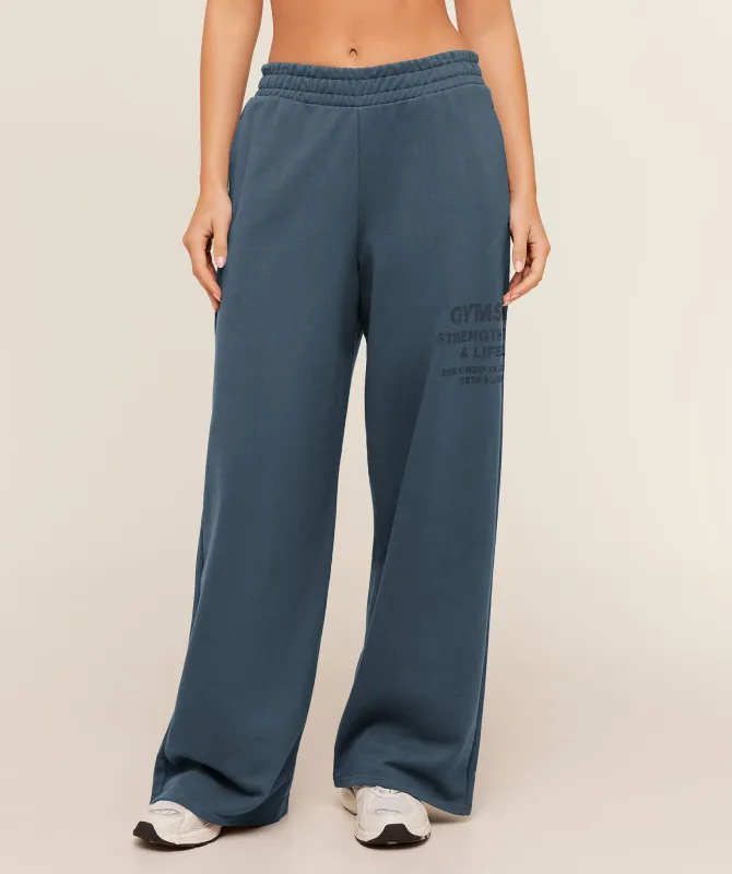 Gymshark Stacked Graphic Wide Leg Jogger - Stealth Blue made by Gymshark