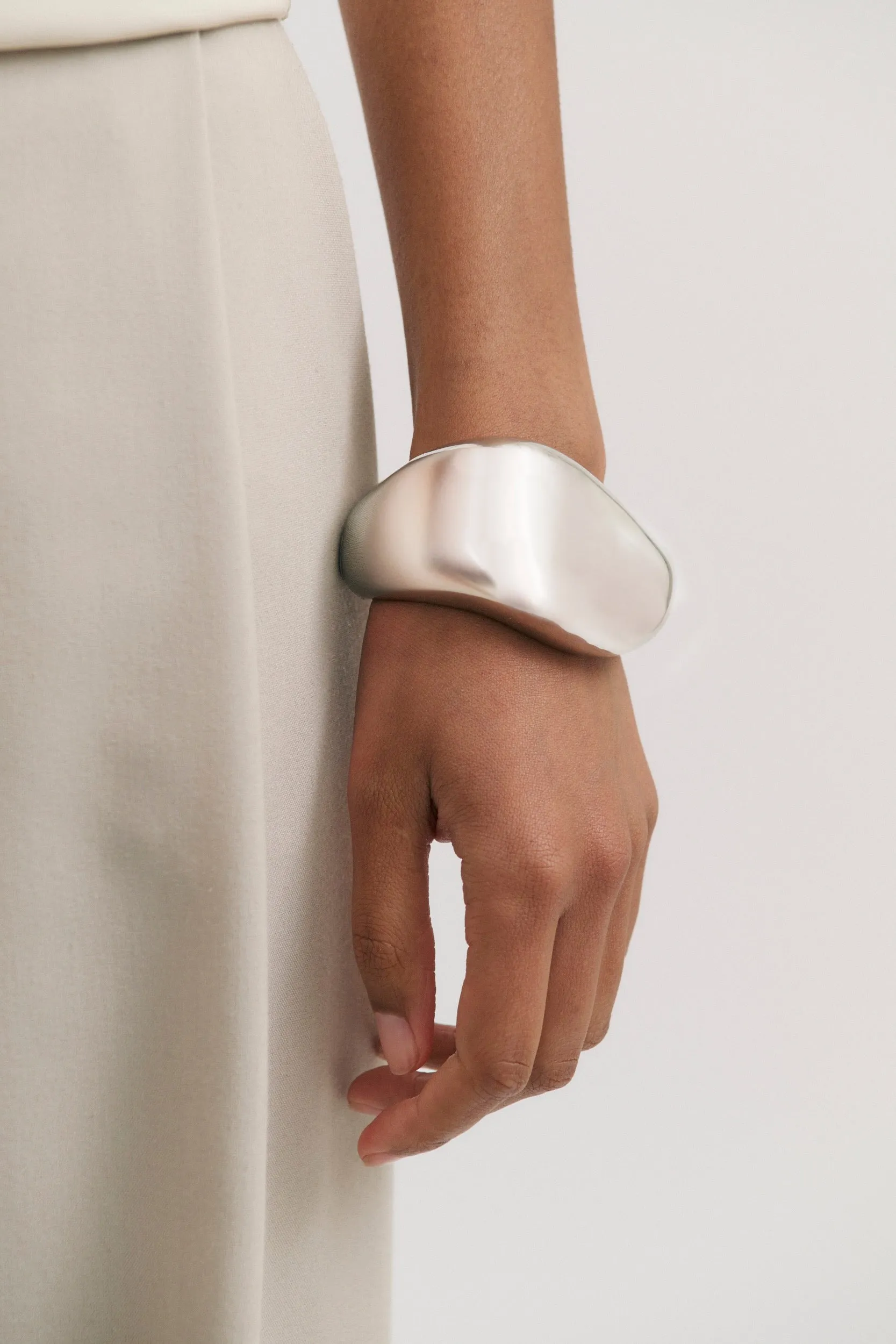 Thick Warped bangle sold by Henne